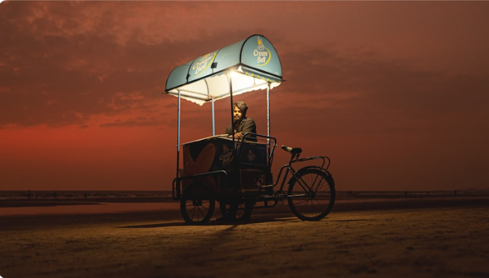 Sunset at Baga Beach with lifeguard tower and motorcycle